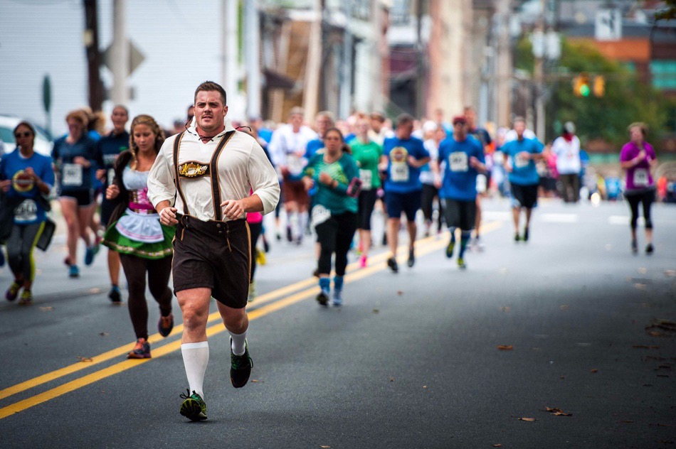 A group of people walking down the street  Description automatically generated