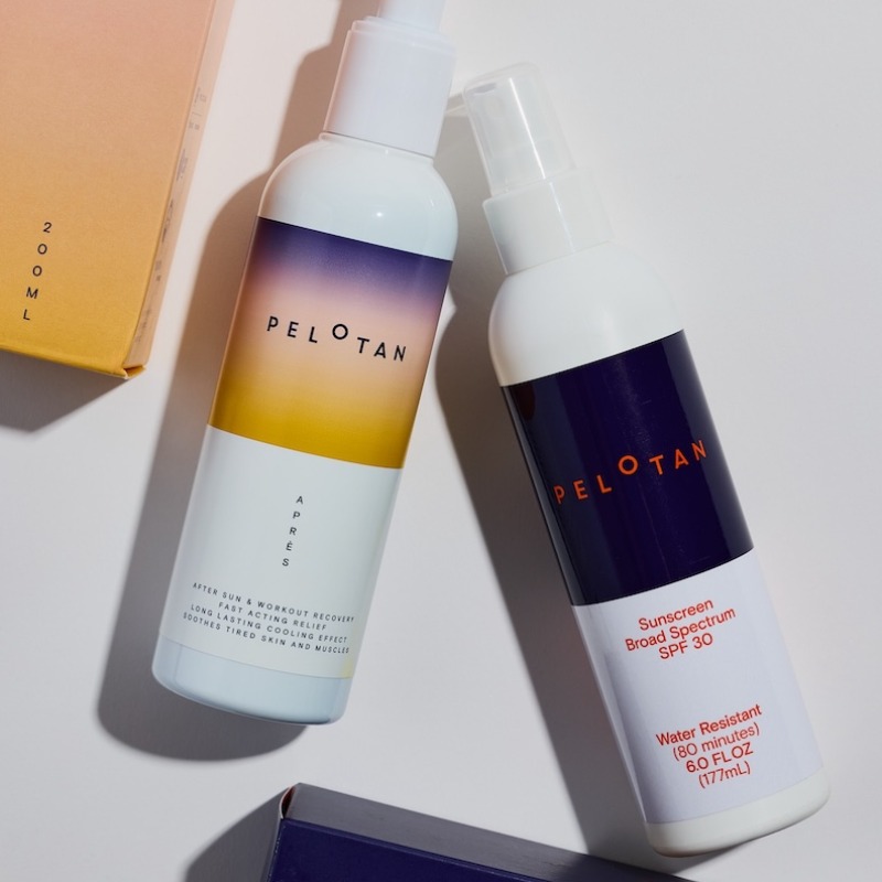 Two white Pelotan spray bottles, featuring After Sun & workout recovery gel and the Broad Spectrum SPF 30 sunscreen, arranged flat against a white background alongside their product packaging boxes.