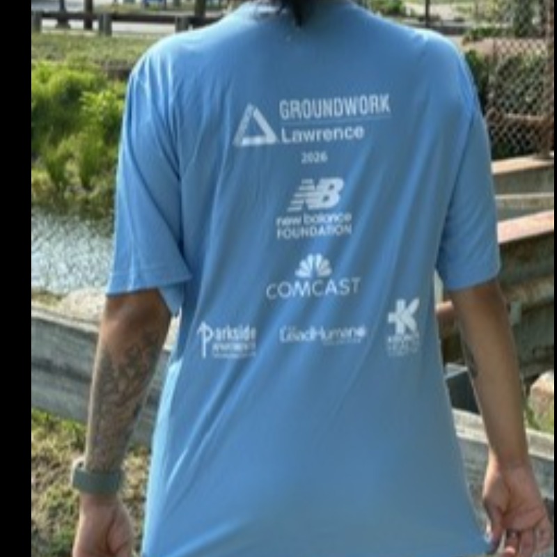 Light blue shirt with event sponsors on back.