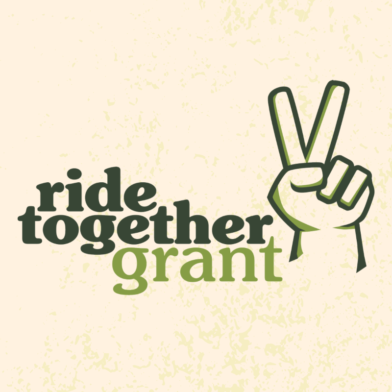 ride together grant text and hand making peace sign