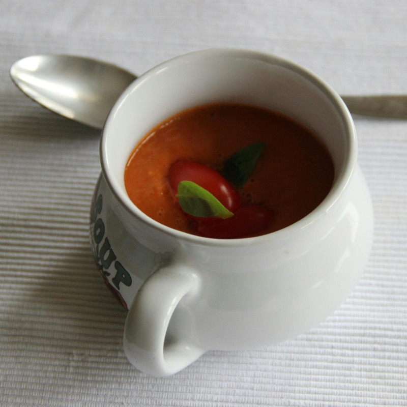 Mug of soup with a spoon